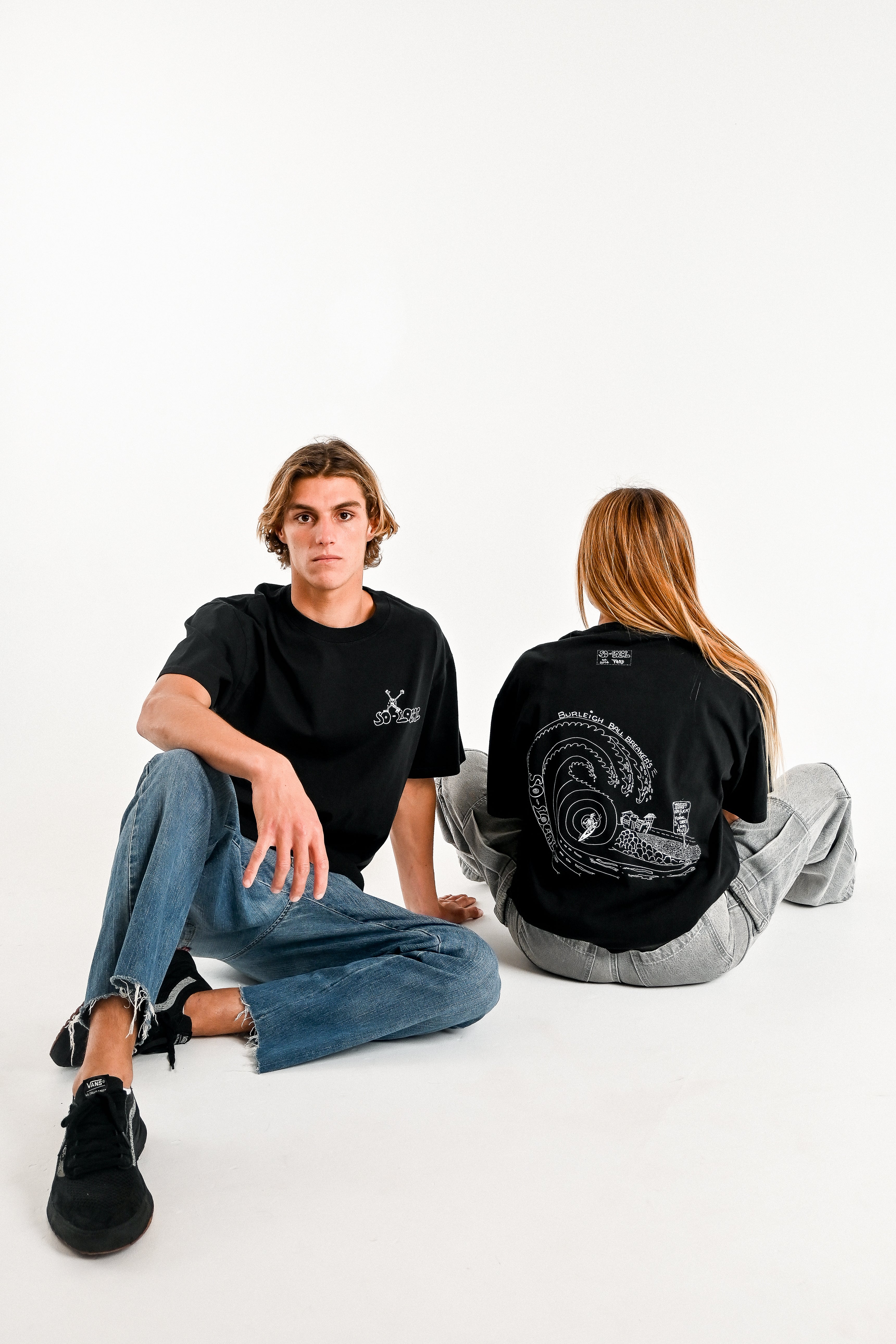 Male and female models wearing BURLEIGH BALL BREAKERS heavy faded t-shirt in black, surf and skate streetwear, studio shot, Gold Coast Australia 
