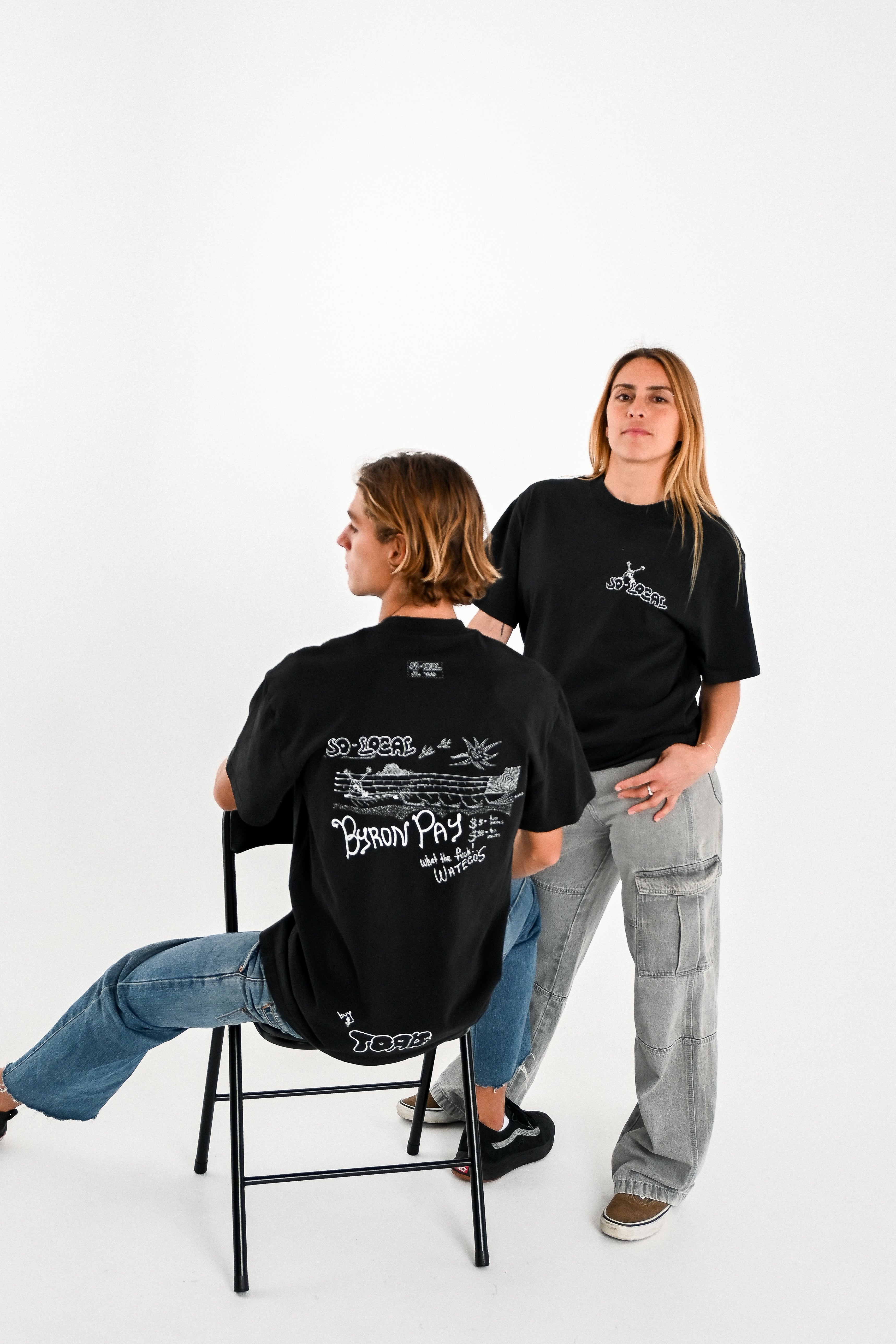 Male and female models wearing BYRON PAY heavy faded t-shirt in black, surf and skate streetwear, studio shot, Gold Coast Australia 