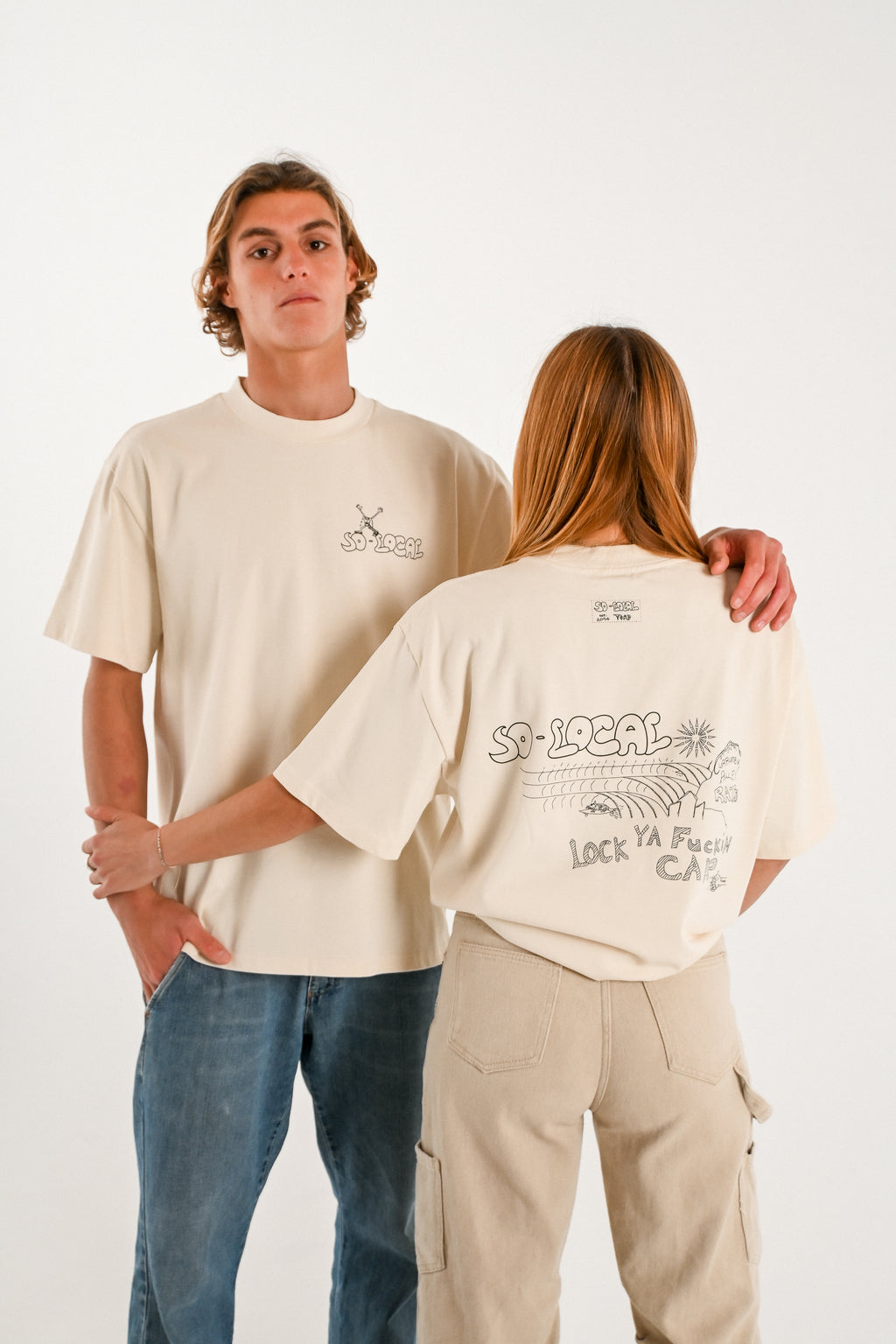 Male and female models wearing CURRUMBIN ALLEY RATS heavy faded t-shirt in butter, surf and skate streetwear, studio shot, Gold Coast Australia 