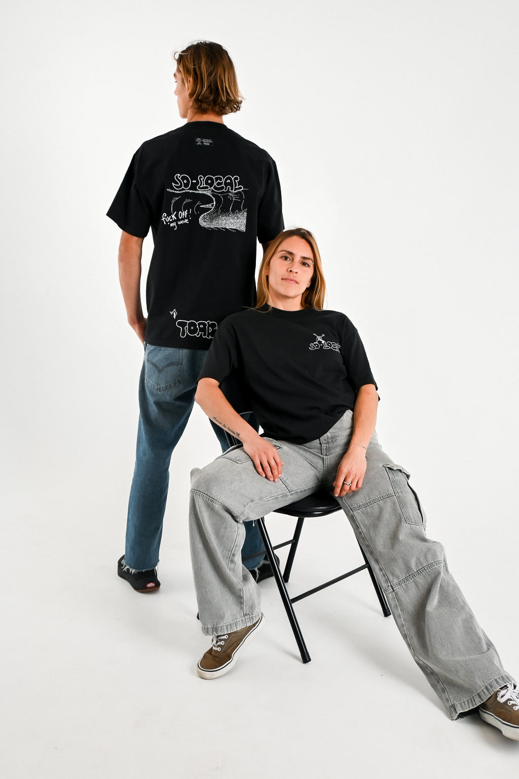 Male and female models wearing F*CK OFF MY WAVE heavy faded t-shirt in black, surf and skate streetwear, studio shot, Gold Coast Australia 