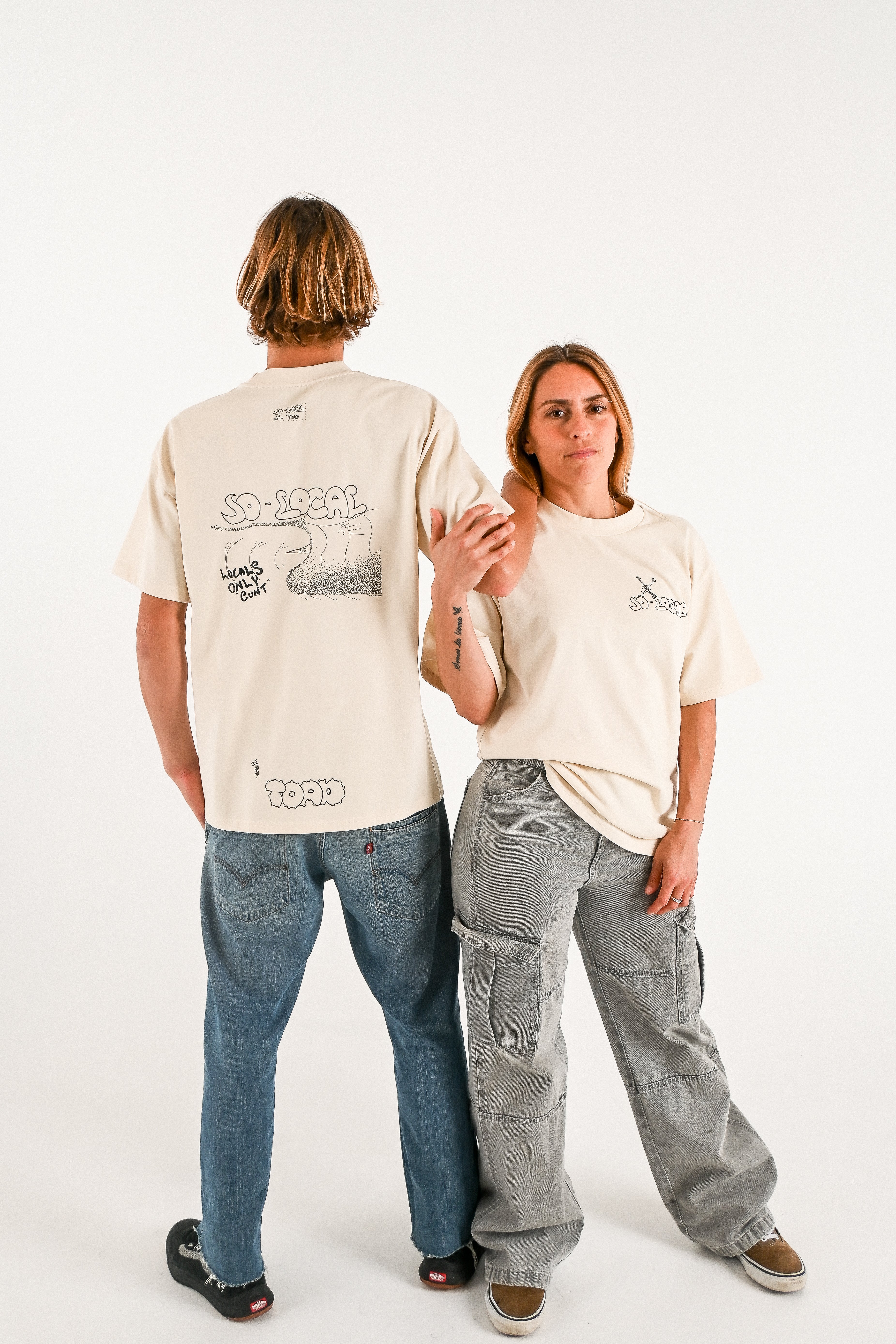 Male and female models wearing LOCALS ONLY C#NT  heavy faded t-shirt in butter, surf and skate streetwear, studio shot, Gold Coast Australia 