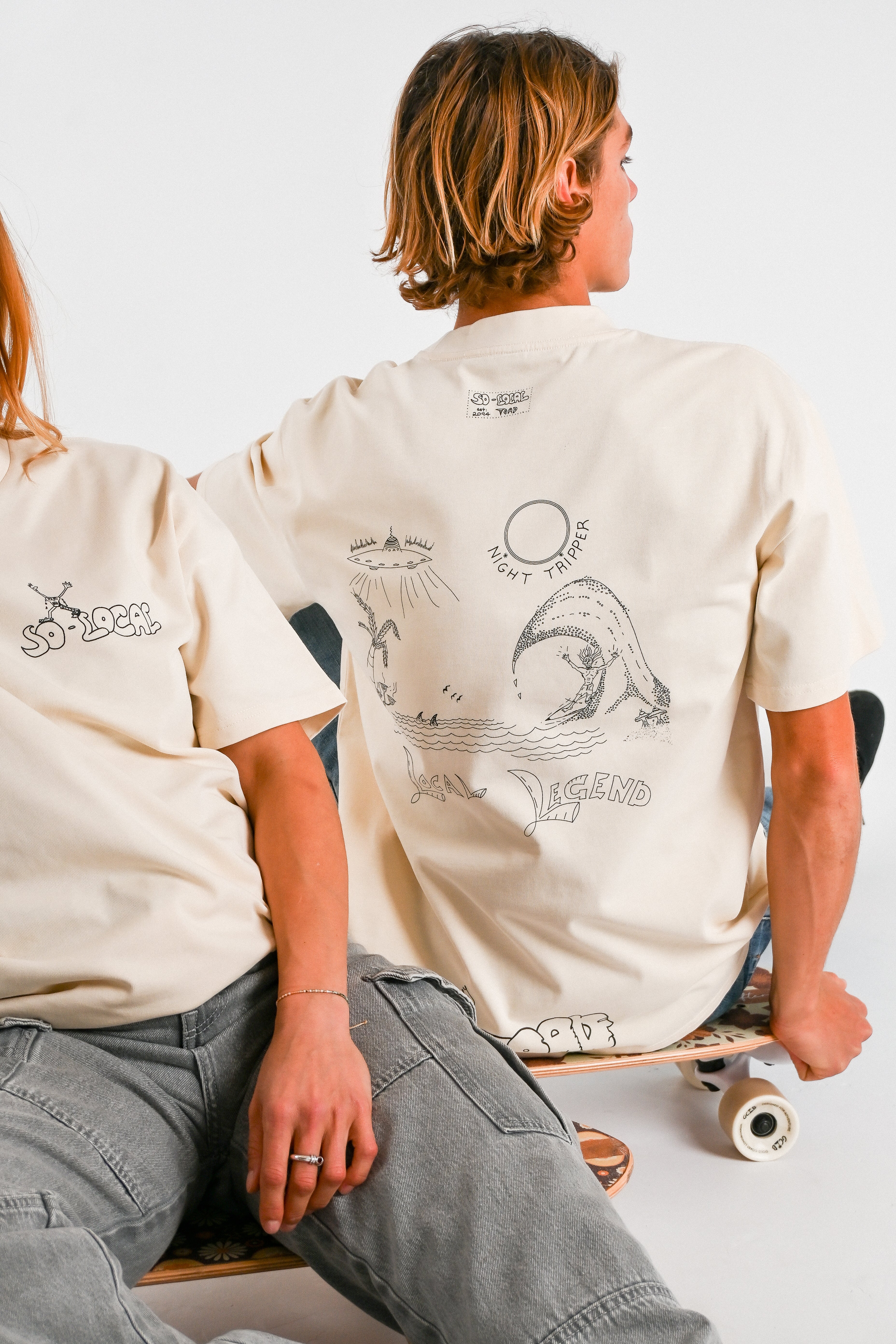 Male and female models wearing NIGHT TRIPPER "Local Legend" heavy faded t-shirt in butter, surf and skate streetwear, studio shot, Gold Coast Australia 