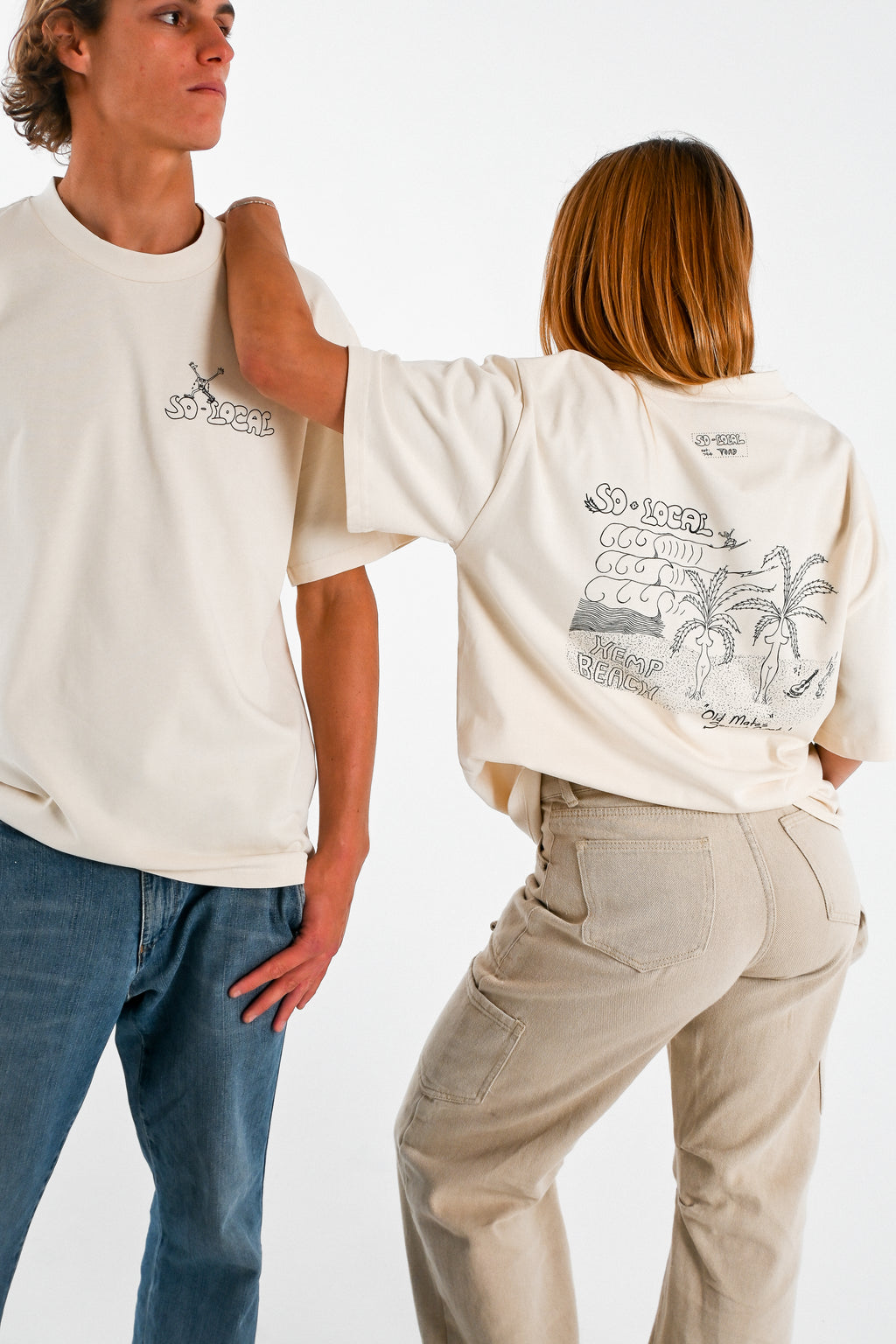  Male and female models wearing OLD MATES SECRET SPOT (Hemp Beach) heavy faded t-shirt in butter, surf and skate streetwear, studio shot, Gold Coast Australia 