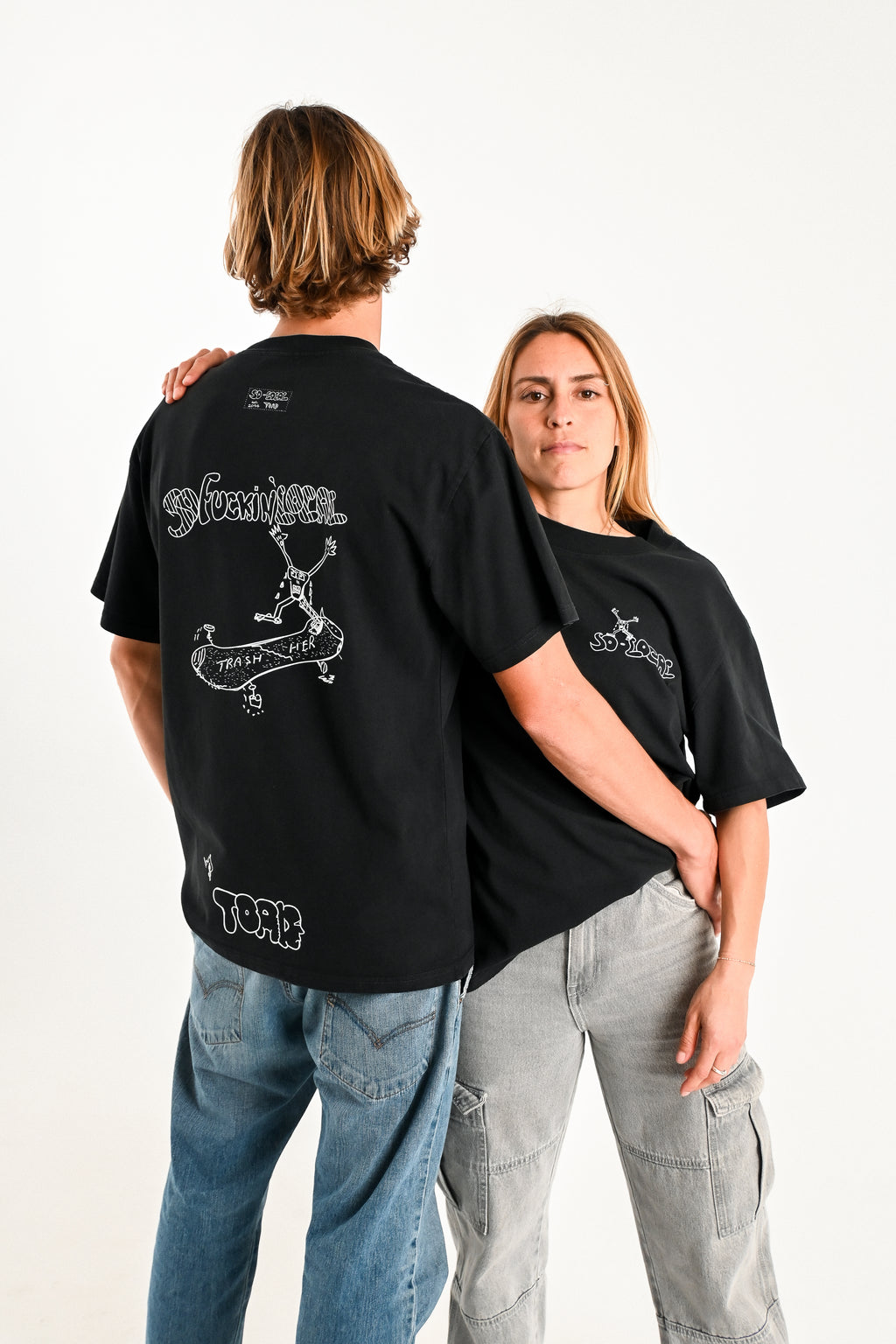 Male and female models wearing SO F*CKING LOCAL "Trash Her" heavy faded t-shirt in black, surf and skate streetwear, studio shot, Gold Coast Australia 