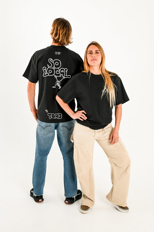 Male and female models wearing SO LOCAL heavy faded t-shirt in black, surf and skate streetwear, studio shot, Gold Coast Australia 