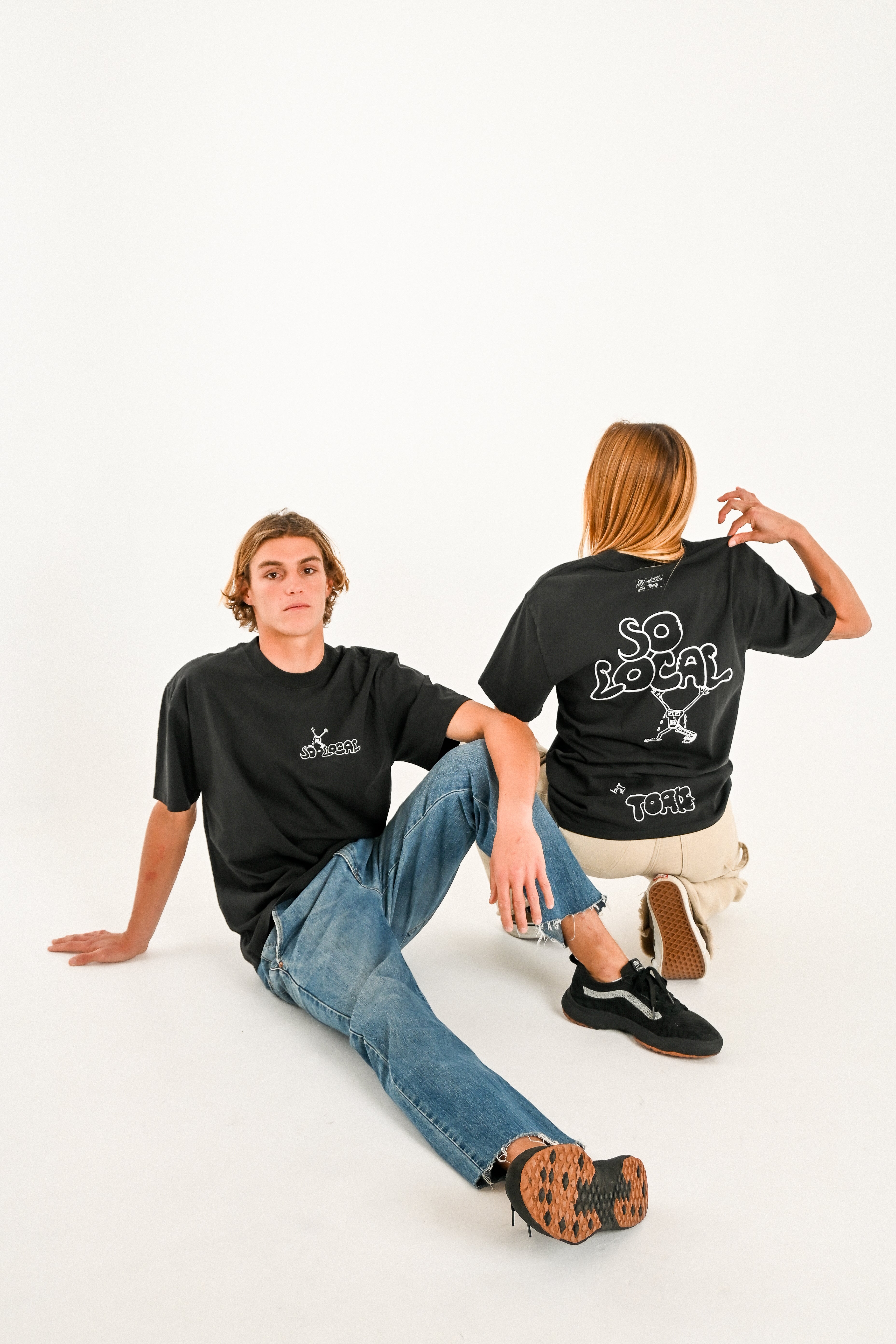 Male and female models wearing SO LOCAL heavy faded t-shirt in black, surf and skate streetwear, studio shot, Gold Coast Australia  