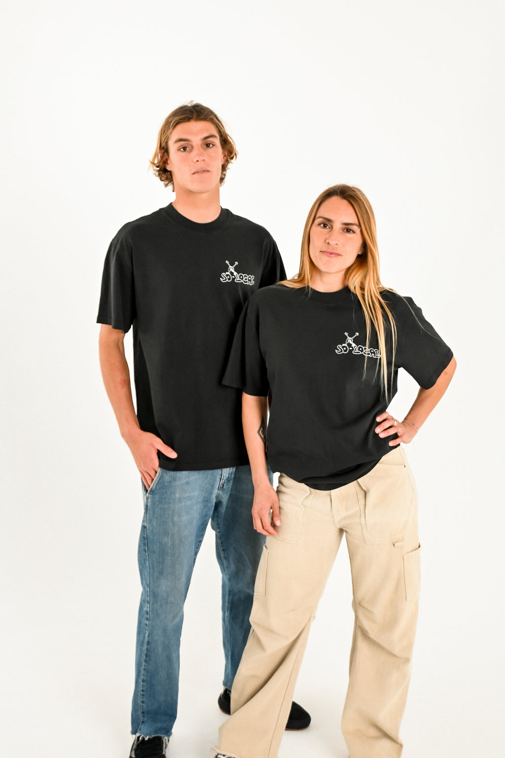 Male and female models wearing SO LOCAL heavy faded t-shirt in black, surf and skate streetwear, studio shot, Gold Coast Australia 