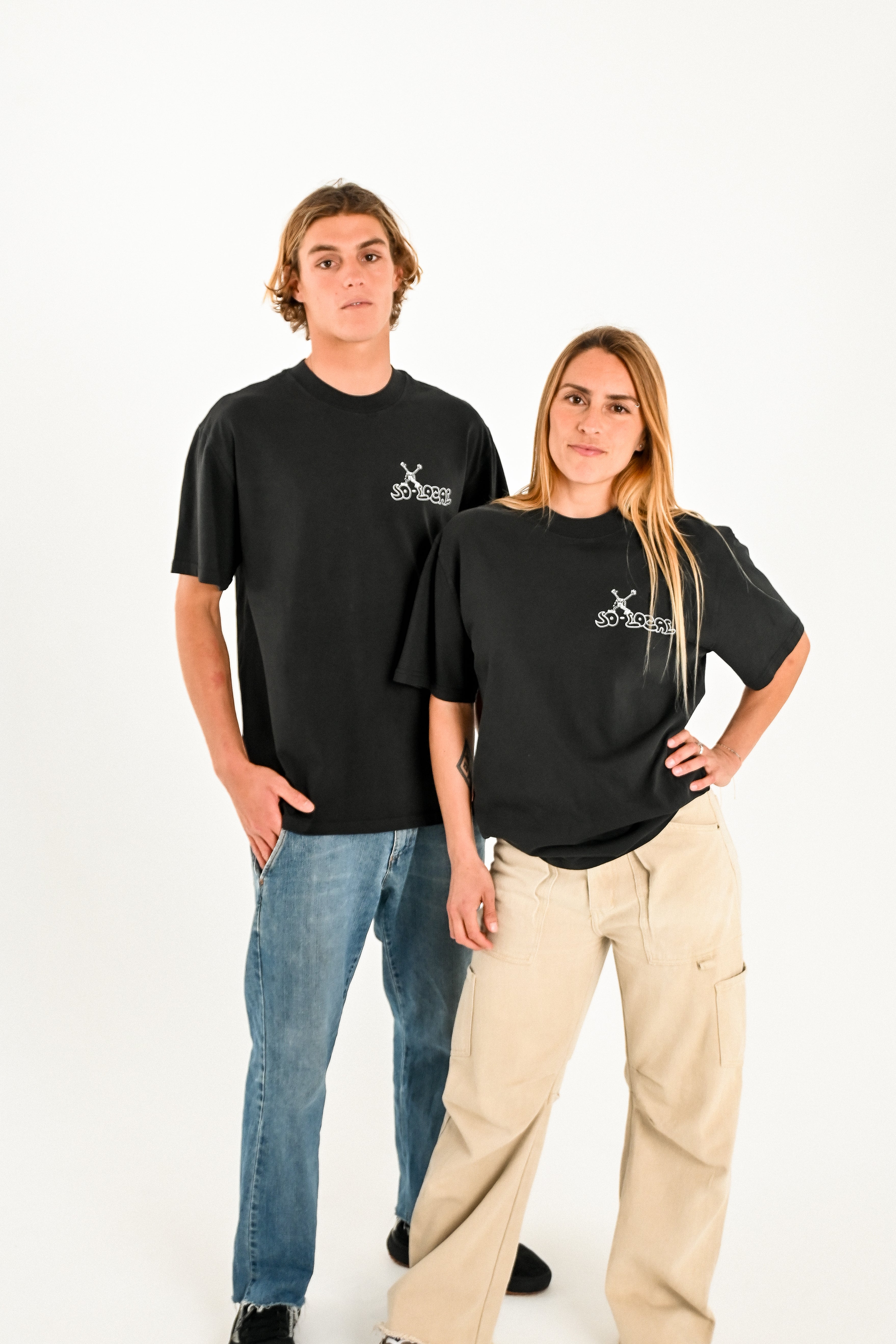 Male and female models wearing SO LOCAL heavy faded t-shirt in black, surf and skate streetwear, studio shot, Gold Coast Australia 
