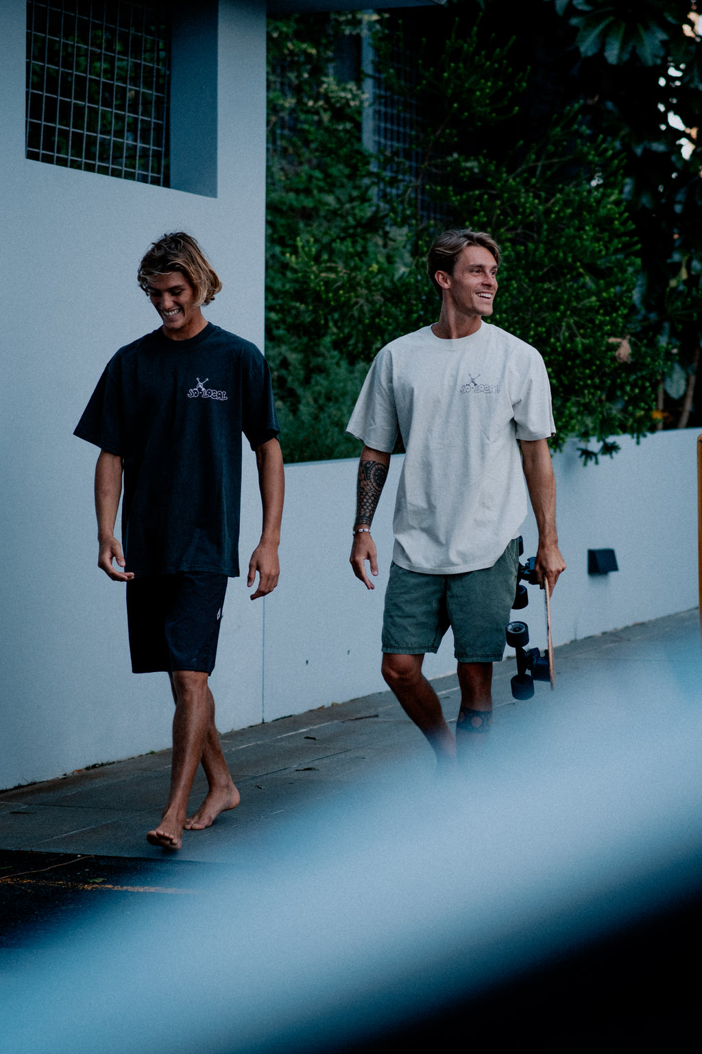 Males models wearing SO LOCAL heavy faded t-shirt in black and white, surf and skate streetwear, lifestyle photo, Gold Coast Australia 
