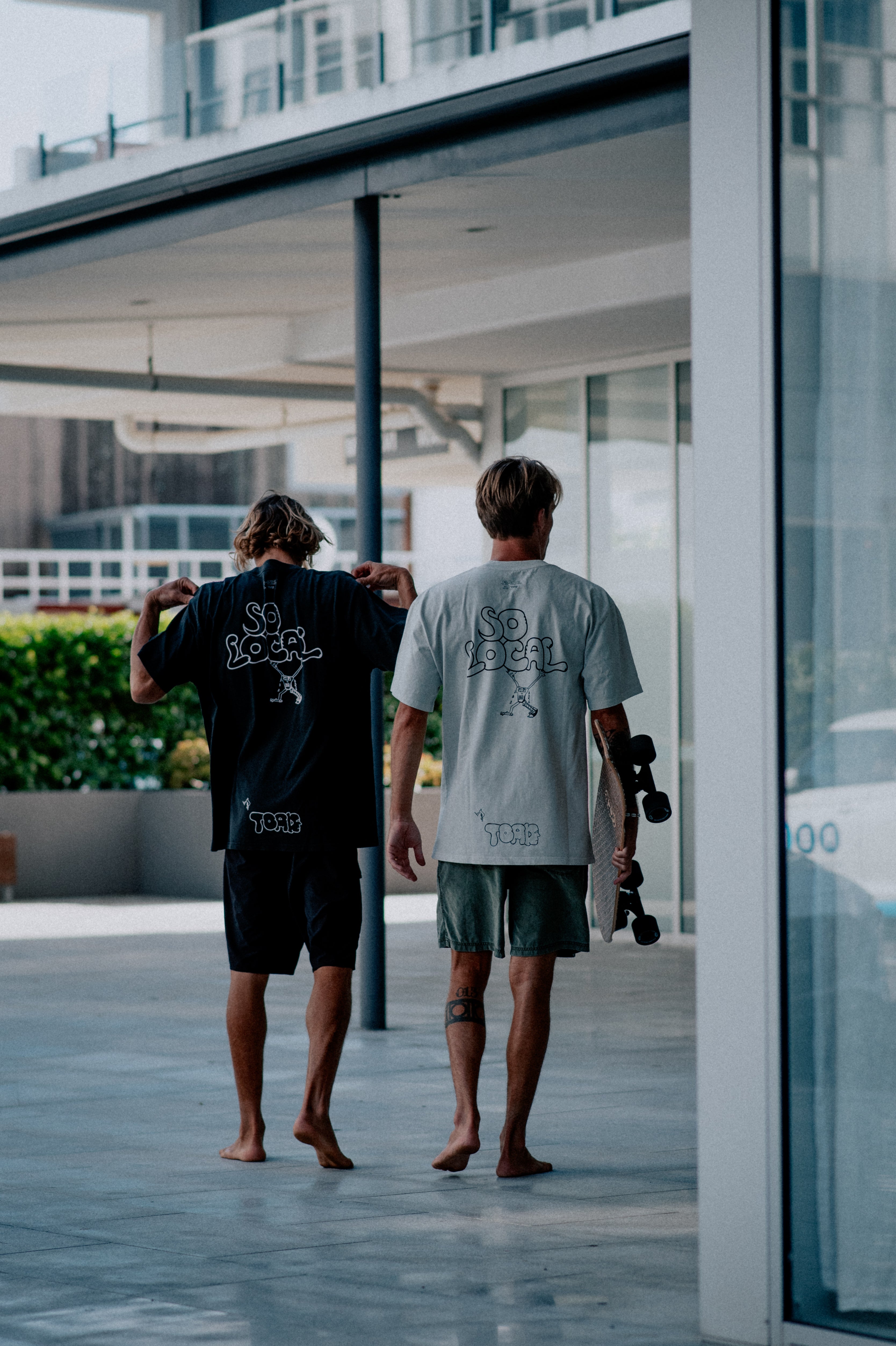 Males models wearing SO LOCAL heavy faded t-shirt in black and white, surf and skate streetwear, lifestyle photo, Gold Coast Australia 