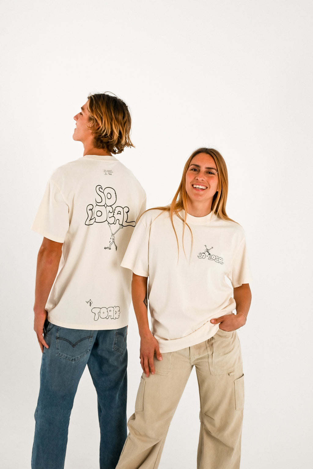 Male and female models wearing SO LOCAL heavy faded t-shirt in butter, surf and skate streetwear, studio shot, Gold Coast Australia 