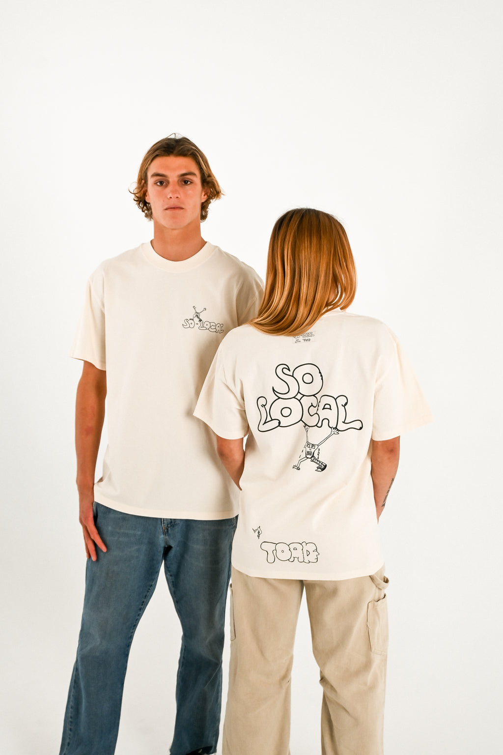 Male and female models wearing SO LOCAL heavy faded t-shirt in butter, surf and skate streetwear, studio shot, Gold Coast Australia 