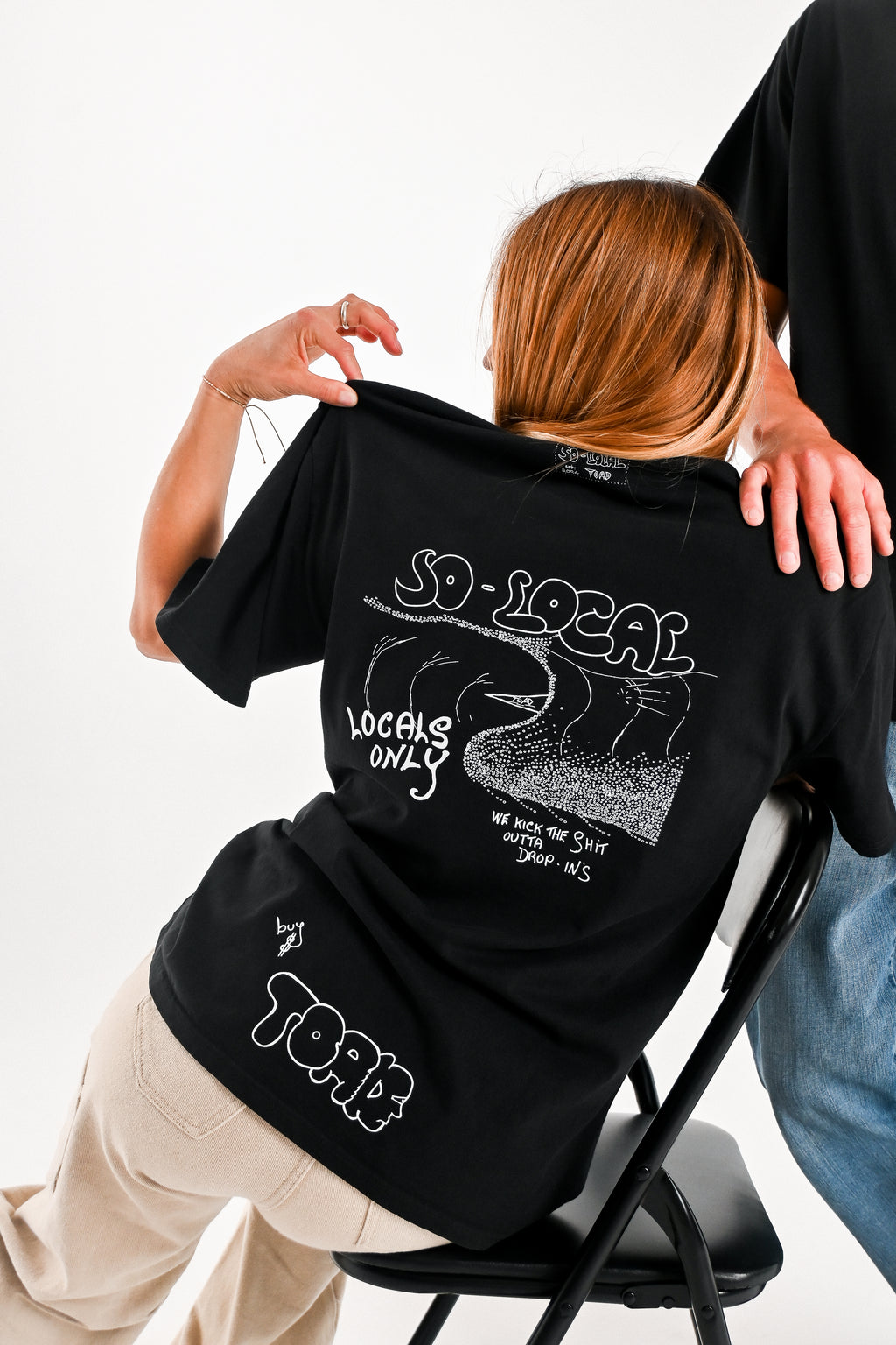 Male and female models wearing WE KICK THE SH*T OUTTA OF DROP IN'S heavy faded t-shirt in black, surf and skate streetwear, studio shot, Gold Coast Australia 