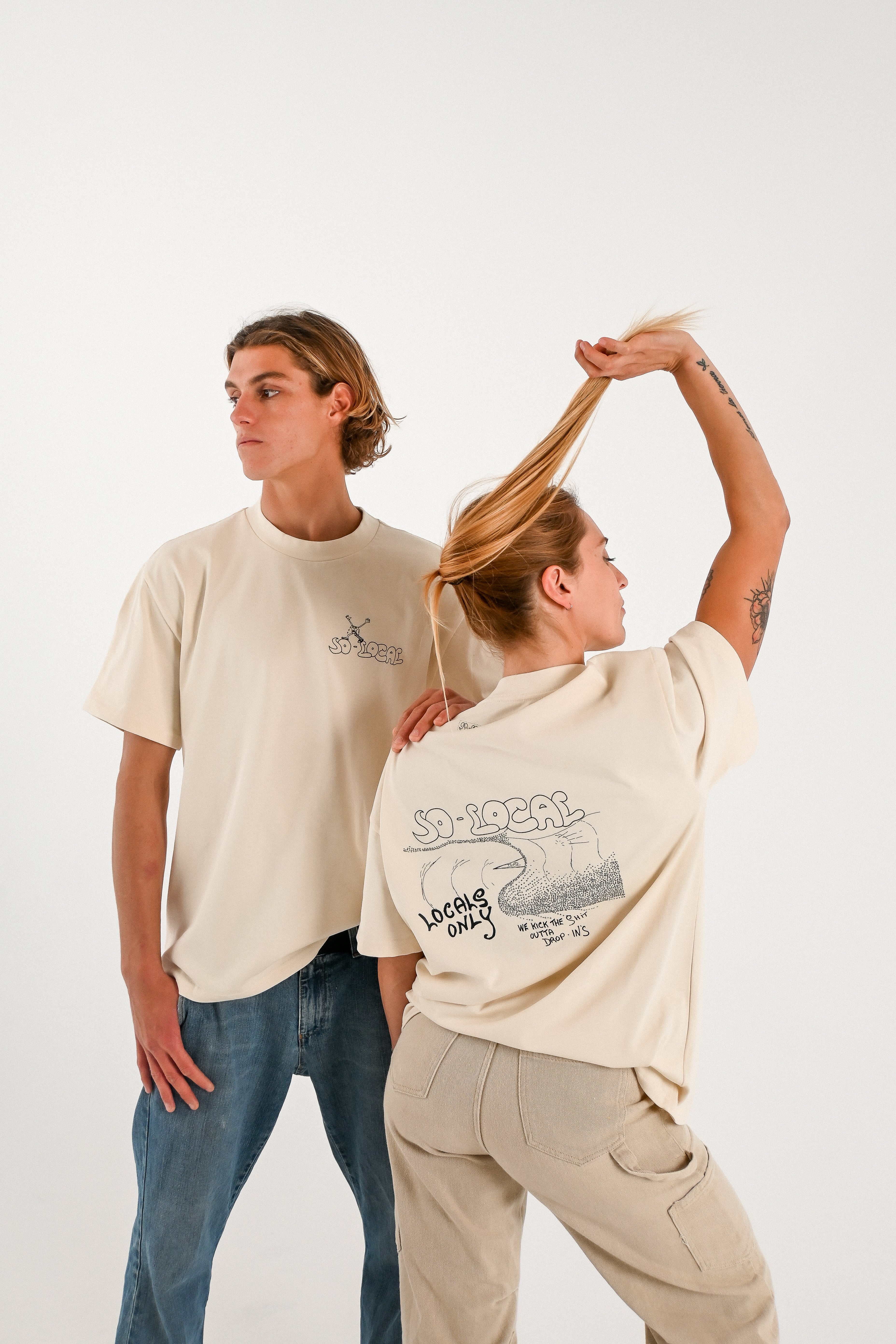 Male and female models wearing WE KICK THE SH*T OUTTA OF DROP IN'S  heavy faded t-shirt in butter, surf and skate streetwear, studio shot, Gold Coast Australia 