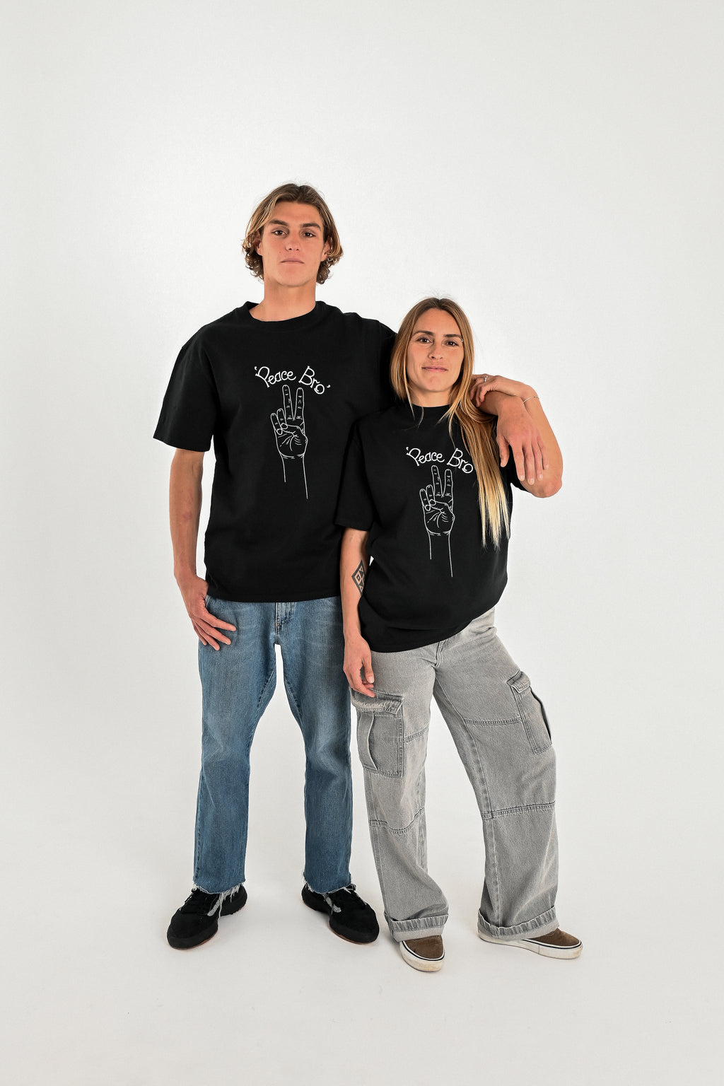 Male and female models wearing PEACE BRO heavy faded t-shirt in black, surf and skate streetwear, studio shot, Gold Coast Australia 