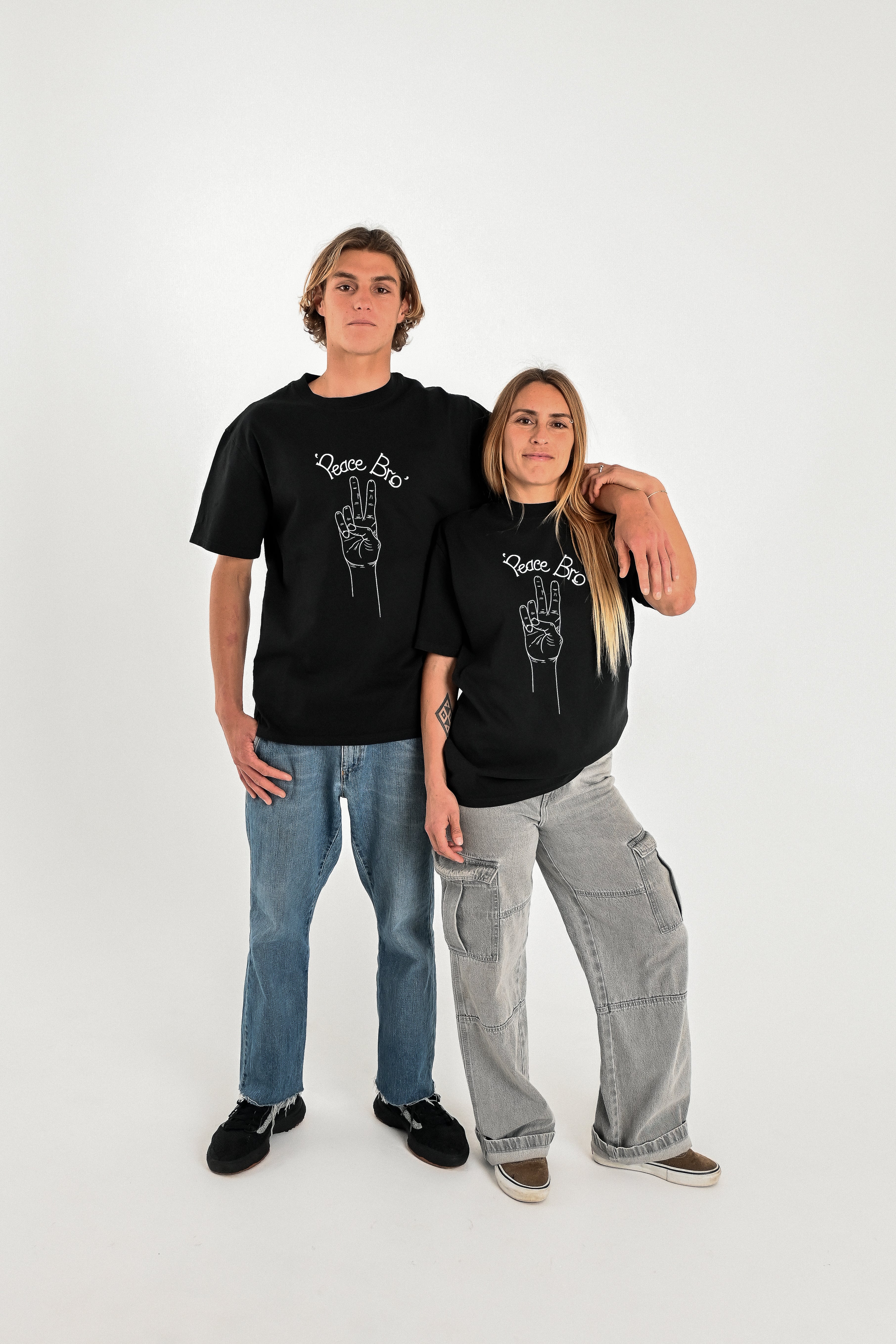 Male and female models wearing PEACE BRO heavy faded t-shirt in black, surf and skate streetwear, studio shot, Gold Coast Australia 